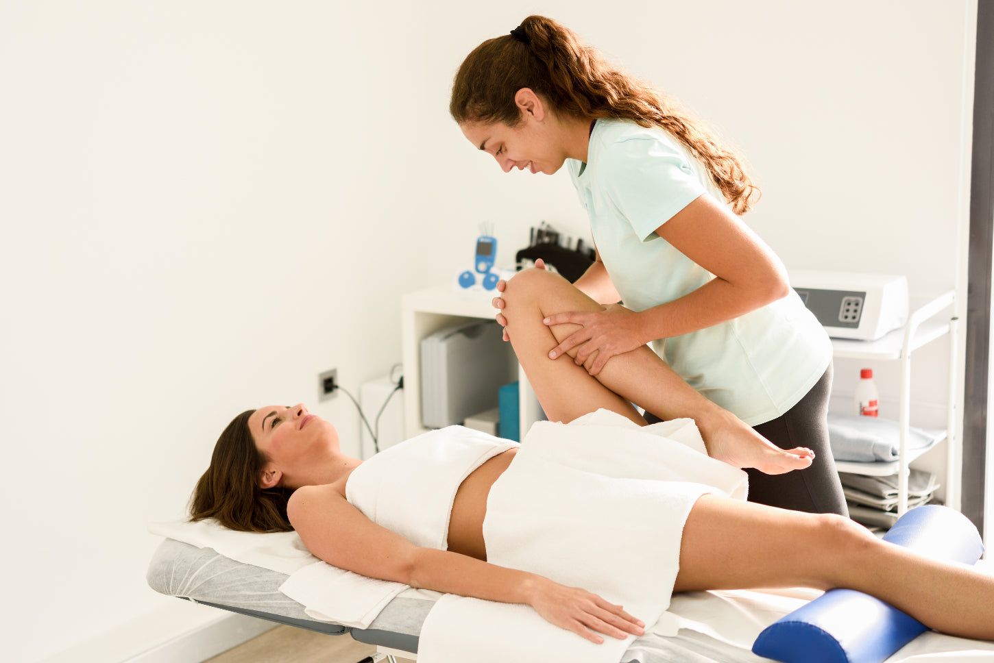 therapist using massage and physical therapy techniques on female client