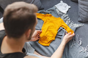 Young father folding new father's day gifts for expecting dads