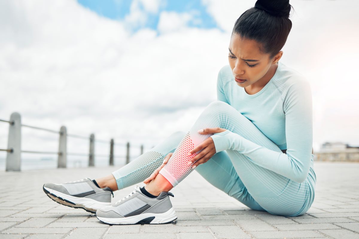 woman massaging her leg soreness